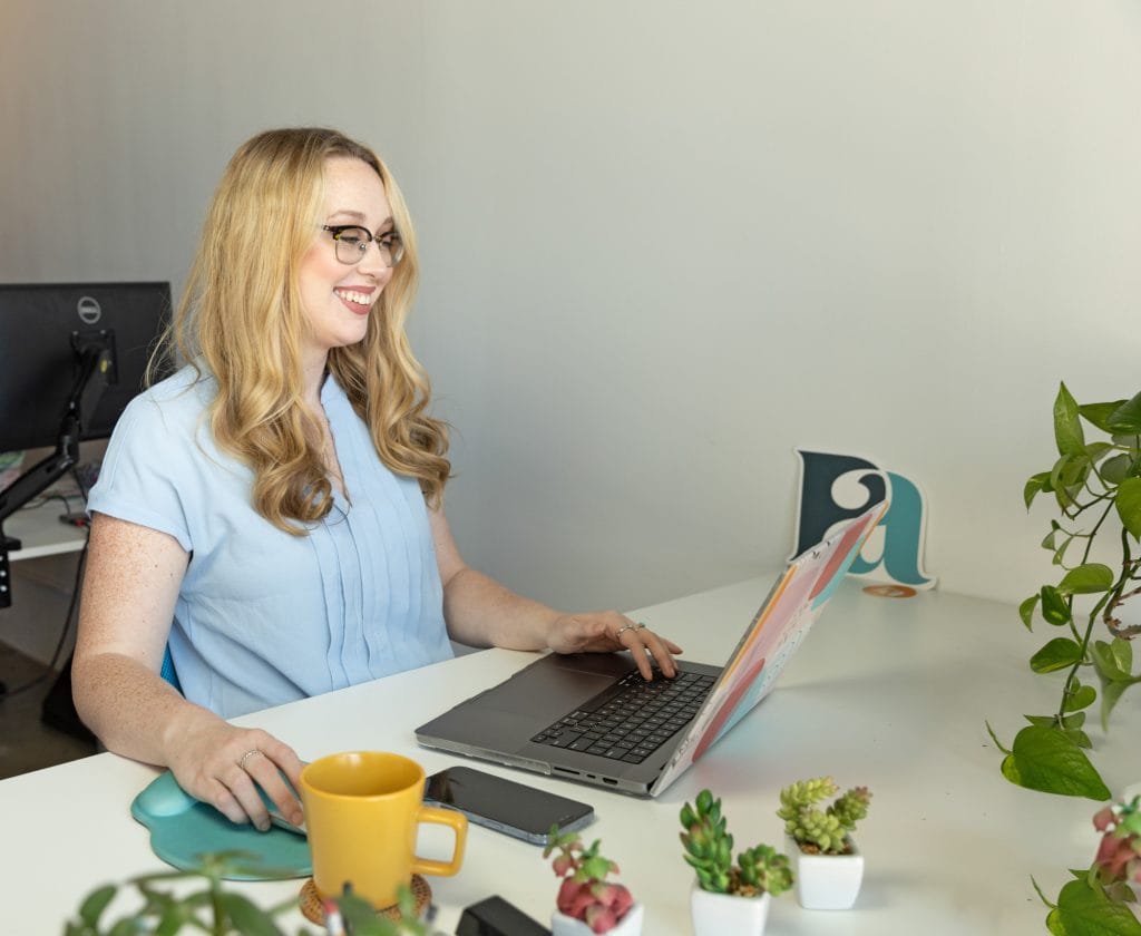Person using laptop in an office environment